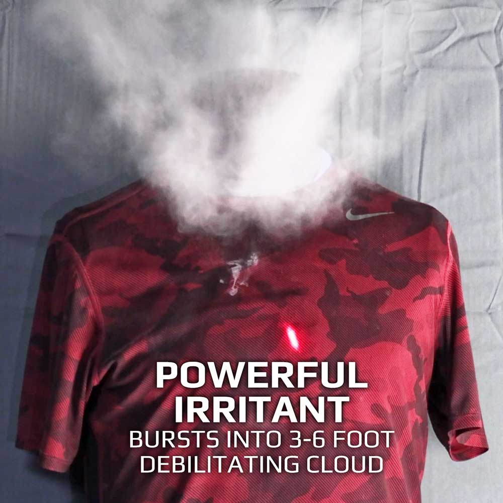 An irritant filled projectile caught mid explosion upon hitting a target dummy. A burst of powder blasts upwards from the chest towards the face area. Text on the image reads "Powerful irritant bursts into a 3-6 foot debilitating cloud"